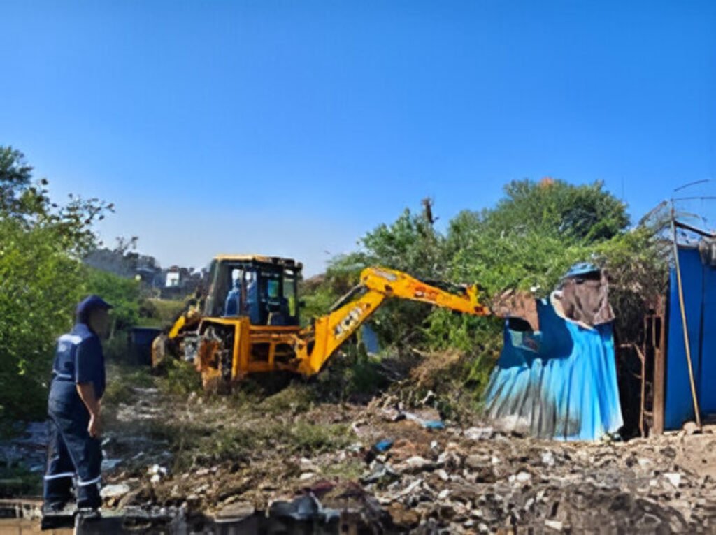 HYDRAA officials carry out an anti-encroachment drive at Durgam Cheruvu near Inorbit Mall in Hyderabad, fencing reclaimed lake land.