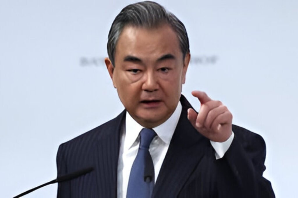 Chinese Foreign Minister Wang Yi addresses a policy symposium in Beijing while speaking on global conflict mediation and regional diplomacy.