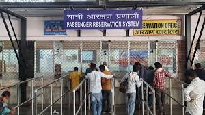 Passengers booking tickets at an Indian Railways counter after the new booking rules came into effect.