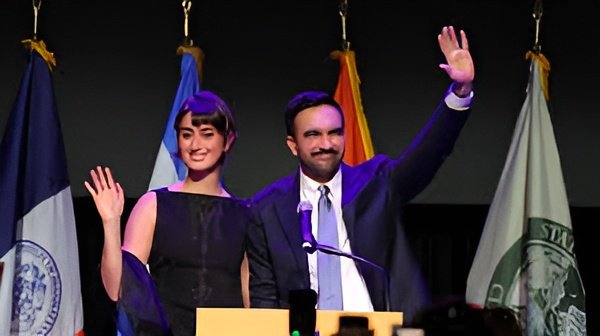 Zohran Mamdani takes oath as NYC mayor, flanked by wife Rama Duwaji and national leaders, as supporters celebrate in Lower Manhattan.