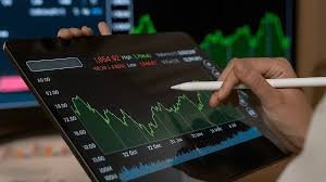 Traders monitor screens outside the Bombay Stock Exchange amid early market decline.