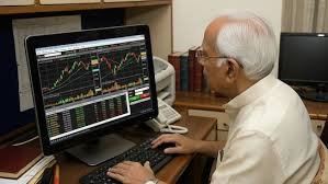 A man checks stock screens outside Bombay Stock Exchange in Mumbai amid market uncertainty over US tariffs.