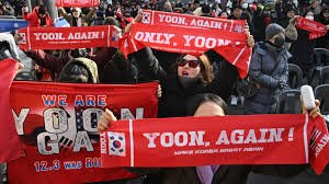 Supporters of former South Korean president Yoon Suk Yeol gather outside a Seoul court during the verdict in his martial law case.