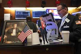 Market screens show declines as investors react to renewed uncertainty triggered by Trump’s Greenland proposal and tariff threats.