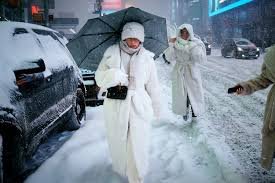 Workers clear snow from city streets as a powerful winter storm disrupts daily life across several U.S. states.